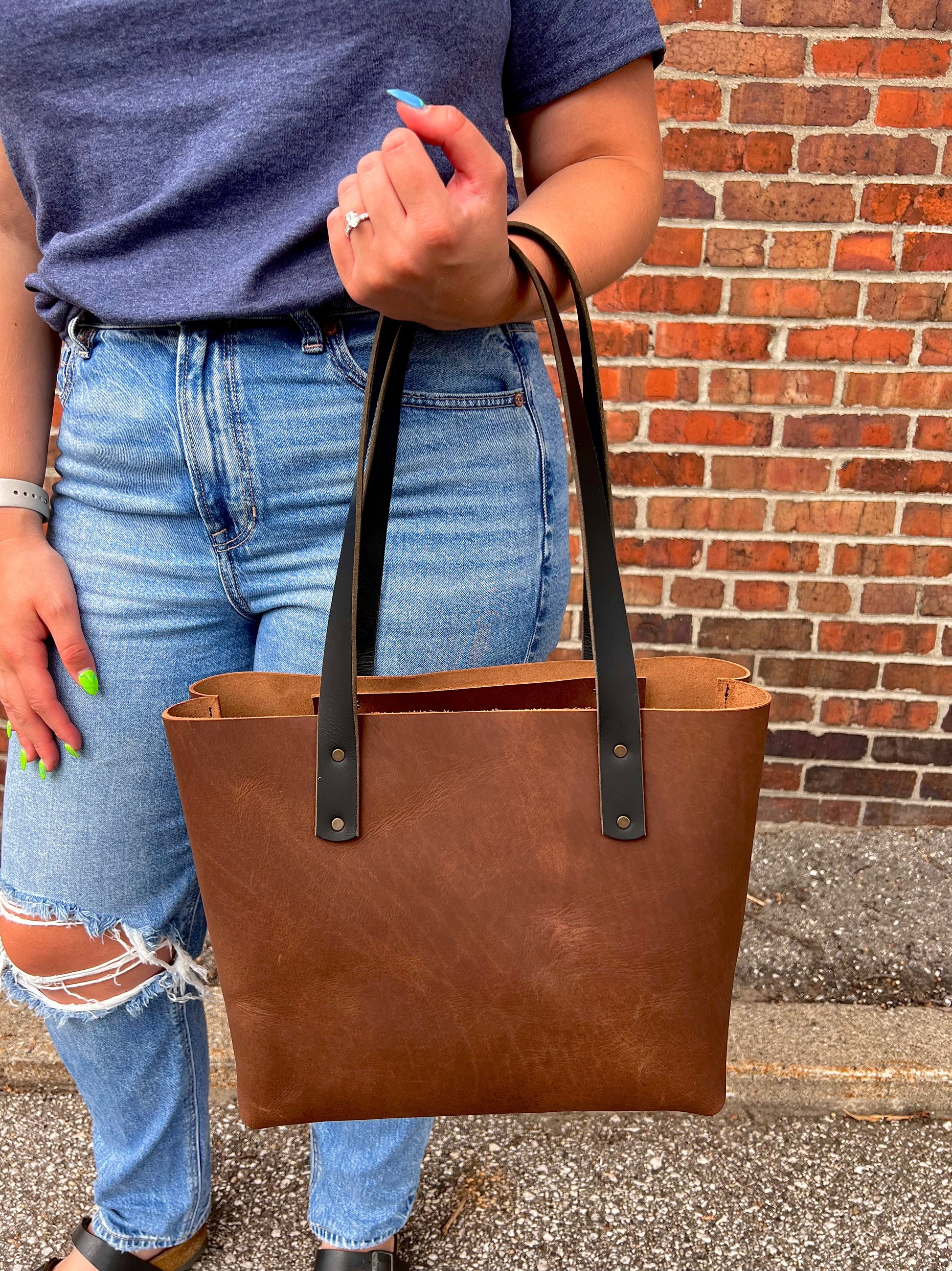 Medium bark brown Wanderer leather tote bag with black leather straps and copper hardware. 
Simple. Rugged. Dependable.