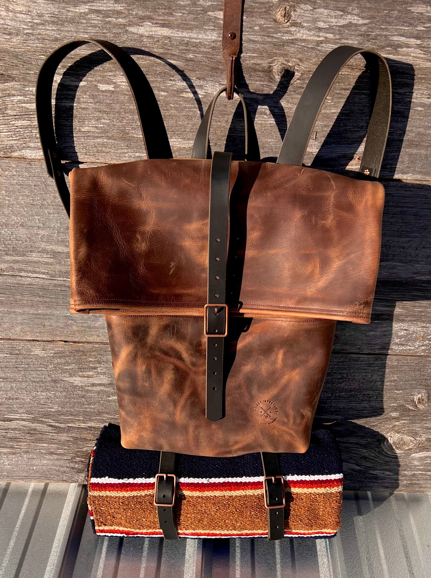 Frontier II Rucksack roll top leather backpack with blanket roll. This bag features black leather straps and copper hardware.