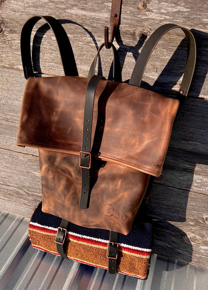 Frontier II Rucksack roll top leather backpack with blanket roll. This bag features black leather straps and copper hardware. 