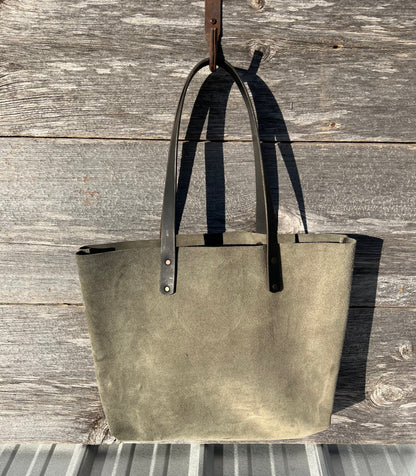 Large green suede leather Wanderer tote bag with black leather straps and copper hardware. 

Simple. Rugged. Dependable. 